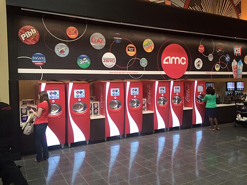Row of Coca-Cola Freestyle machines inside a theater lobby